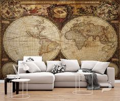 a living room with a couch and a large map wall mural on the wall behind it