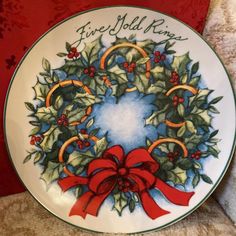 a christmas plate with holly wreath and red ribbon