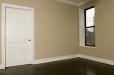 an empty room with a door and window