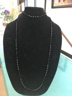 "This stunning necklace modeled after one wore by Lady Mary in the Downton Abbey series manages to be impossibly delicate yet incredibly dramatic at the same time. It is made from 50\" of tiny, 2mm glittering faceted black spinel beads interspersed with sections of smooth 6mm polished black onyx. This is a VERY long necklace in the style of that day. It can be worn as one long necklace (if you're tall or going for the true '20s look) but it's also meant to be looped again over the head, as a cho Elegant Black Beaded Lariat Jewelry, Elegant Black Beads Lariat Jewelry, Elegant Beaded Black Spinel Jewelry, Elegant Black Lariat Beaded Necklace, Elegant Black Spinel Beaded Necklace, Long Beaded Chain Necklace For Evening, Evening Long Necklace With Beaded Chain, Elegant Double Strand Beaded Necklace With Black Beads, Elegant Double Strand Necklace With Black Beads