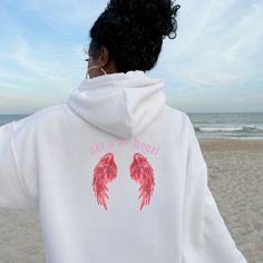 Get ready to make a statement with our 'Did you know' hoodie exuding all the coquettish charm and downtown cool of the Y2K era! On the front, intrigue builds with those three simple words, sparking curiosity and drawing in attention. But the real surprise awaits on the back, where bold red sparkly angel wings spread wide, accompanied by the playful declaration: 'She's an Angel.' This hoodie is a nod to the mysterious allure of the early 2000s, blending sass with sweetness in perfect harmony. With its flirtatious vibes and unmistakable style, it's the ultimate choice for those who like to keep everyone guessing. Wear it with attitude, and let your inner angel shine through!" This unisex heavy blend hooded sweatshirt is relaxation itself. Made with a thick blend of cotton and polyester, it f Angel Wings Hoodie, Hoodie Y2k, Y2k Era, Perfect Harmony, Simple Words, An Angel, Early 2000s, Angel Wings, Hooded Sweatshirt