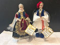 two figurines that are standing next to each other