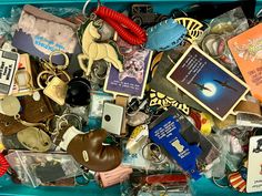 a blue box filled with lots of different types of keychains and other items