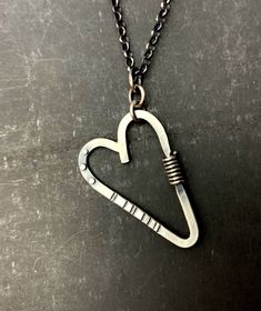 "This sweet-but-not-too-sweet heart necklace is all sterling silver. The pendant is made from stock materials: 12g. round wire for the heart, 20g. rivets, 18g. wrapped wire, 16g. Soldered jump rings connect the pendant to the 18\" long, rolo chain. Handmade T-bar clasp. The back of the pendant has been stamped: stelzer, sterling, handwrought, shown in last pic. The heart is about 1-5/8\" long and 1-2/16\" wide." Sterling Silver Heart Necklace Wire Wrapped, Heart-shaped Sterling Silver Soldered Necklace, Sterling Silver Heart-shaped Soldered Necklaces, Sterling Silver Heart-shaped Soldered Necklace, Sterling Silver Heart Necklace With Soldered Details, Small Heart Pendant, Sea Glass Ring, Portsmouth Nh, Attention Seeking