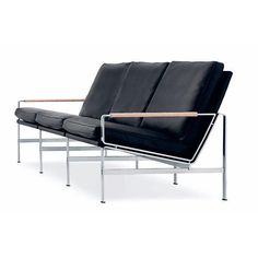 a black couch sitting on top of a metal frame