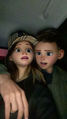 two dolls are sitting in the back seat of a car