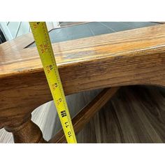 a wooden bench with a measuring tape on it