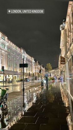 a city street at night with rain on the ground