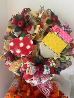 a tree made out of many different items on top of some leaves and pumpkins