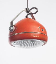 a red light hanging from a ceiling fixture