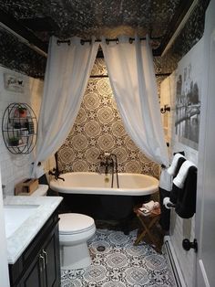 an old fashioned bathroom with black and white decor