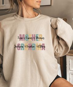 a woman wearing a sweatshirt with the words mother on it