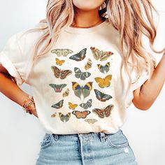 Add a touch of whimsy to your wardrobe with this charming butterfly t-shirt! Made with high-quality and comfortable fabric, this T-shirt features a vintage style butterfly design that adds a pop of color to any outfit.  COLORS: Ivory, Espresso, Pepper, Moss, Blue Jean, Black DETAILS: * Comfort Colors® brand shirts. * 100% ring-spun cotton. * Medium fabric. Relaxed fit.  PRINT: * High quality DTG (Direct-To-Garment) printing, using eco friendly water-based ink, printed directly into the fabric. * White Butterfly Print Graphic Tee, Spring Butterfly Graphic Print Top, Cute Butterfly Print Crew Neck T-shirt, Spring Graphic Tee With Butterfly Print, Summer Graphic Tee With Butterfly Print, Cute Butterfly Print T-shirt For Spring, White Butterfly T-shirt For Spring, Vintage Butterfly Print T-shirt For Summer, Multicolor Cotton T-shirt With Butterfly Print