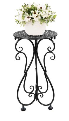 an iron table with a flower pot sitting on it's top and the base is black