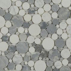 a white and grey tile with circles on it