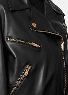 A biker-inspired leather jacket with Medusa hardware and a diagonal zipper. The outerwear style features a belted waist and zipped pockets. Luxury Leather Jacket With Zipper Closure, Luxury Belted Biker Jacket For Fall, Luxury Leather Biker Jacket With Asymmetrical Zip, Luxury Biker Jacket With Asymmetrical Zip For Fall, Luxury Leather Outerwear With Asymmetrical Zip, Luxury Asymmetrical Zip Biker Jacket For Fall, Belted Biker Jacket For Workwear, Luxury Long Sleeve Biker Jacket For Biker Events, Luxury Leather Outerwear With Belt Loops