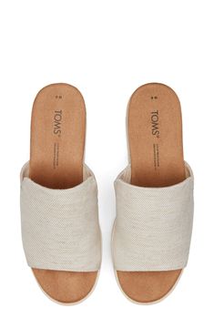 Braided jute adds beachy charm to the sporty-chic midsole of this canvas wedge sandal set on a lightweight sawtooth sole. 2 1/4" heel; 1 1/4" platform (size 8.5) OrthoLite® Eco™ X-40 Hybrid footbed Cushioned footbed Textile upper and lining/synthetic sole Imported TOMS is a Certified B Corporation, which meets standards for verified social and environmental performance, public transparency and legal accountability to create a more inclusive and sustainable economy TOMS gives a minimum of one-thi Casual Slip-on Wedge Sandals With Textured Sole, Casual Espadrille Wedge Slip-on Sandals, Summer Wedge Heel Espadrilles With Branded Insole, Beige Open Toe Canvas Sandals, Summer Textile Wedge Sandals With Removable Insole, Textile Platform Wedge Sandals For Summer, Comfortable Wedge Sandals With Textured Sole For Vacation, Textile Wedge Sandals With Round Toe For Summer, Textile Wedge Sandals With Woven Sole For Summer