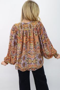 Indulge in the vibrant colors and elegant print of our paisley print smocked yoke top! The flowy fit and blousy sleeves add an effortlessly chic touch, while the self tie neckline offers versatility and charm. Perfect for adding a pop of style to your fall wardrobe! Take this top from the office to dinner with friends! Paisley printed blouse Flowy fit Chiffon fabric Metallic threading Blousy sleeves Self tie neckline Katie is 5'4" wearing a small Paisley chiffon top Fall chiffon top Fall Loungewear, Printed Chiffon Tops, Yoke Top, Paisley Print Blouse, Short Leggings, Print Chiffon, Chiffon Top, Shop Swimwear, Threading