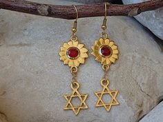 Star Of David Earrings. Gold Jewish Jewelry. Red Swarovski Earrings. Drop Jewish Symbolic Earrings. Magen David Star Charms Jewelry Gift Materials:Metal: 24K gold plated on brass nickel freeGemstone:  swarovski Measurements:Long: 4 cm \ 1.6 InchesThe earrings will be packed in a gift box.Please allow 4-5 days to prepare. I usually ship earlier than this.If you are in a rush, please let me know.FOR MY JEWISH COLLECTION HERE:https://www.etsy.com/il-en/shop/rebekajewelry?section_id=14238096&ref=sho Red Star-shaped Nickel-free Earrings, Nickel-free Red Star Earrings, Handmade Red Star Jewelry, Red Spiritual Dangle Earrings, Red Spiritual Jewelry, Ruby Red Necklace, David Star, Jewish Jewelry, Heart Shaped Necklace