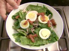 a salad with hard boiled eggs and bacon