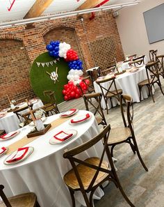 a banquet room with tables and chairs set up for an american flag themed party or celebration