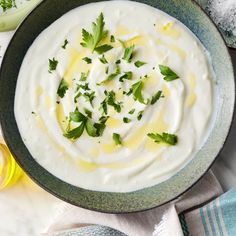 a bowl filled with sour cream and garnished with parsley