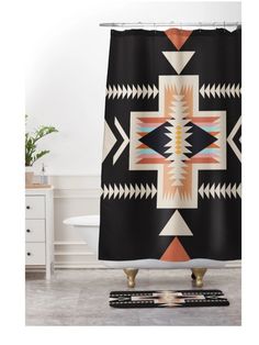 a black and white shower curtain with an arrow design on the bottom, in front of a bathtub