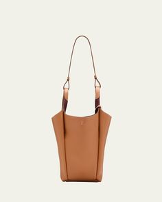 Tod's bucket bag in grained calf leather     Fixed top handles, 12.6" drop     Hook closure     Removable pendant with branded metal T Timeless accessory    Interior, two slip pockets     Lining: Leather/nylon/polyurethane    Approx. 12.6"W x H 11.8"H x 4.7"D    Made in Italy Luxury Tan Bucket Bag For Everyday Use, Classic Tan Bucket Bag, Luxury Tan Bucket Bag With Double Handle, Tan Bucket Shoulder Bag With Removable Pouch, Tan Shoulder Bucket Bag, Luxury Tan Double Handle Bucket Bag, Designer Tan Bucket Bag With Leather Handles, Designer Tan Bucket Bag For Everyday, Tan Leather Handle Bucket Shoulder Bag