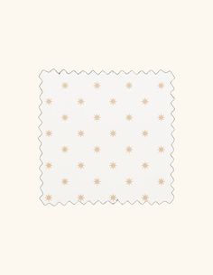 a white and gold paper with small stars on it