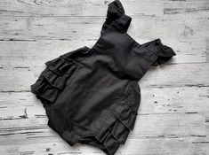 "How about a Black romper perfect for summer!  So crisp and vintage with a modern twist  with luscious black ruffles!  Your little princess will look so cute in this little vintage looking ruffled bottom romper.  It has the black fabric straps which criss cross in the back and has flutter sleeves.  They snap at the back waist and have two options that give her room to grow! Front is fully lined.  100% cotton fabric is machine washable in cold, tumble dry low.  I hope you love this little romper Girl 1st Birthday Cake, Halloween Party Girls, Baby Bubble Romper, Black Toddler, 1st Birthday Cake Smash, Girl 1st Birthday, Baby Bubble, Toddler Romper, Romper Black