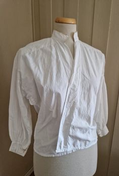 Size Medium to Large . White blouse made of 100% cotton. It was found together with Edwardian clothing, so I guess it is from the same period. It has a wide front opening to be tucked into the skirt .It has mother of pearl buttons at the sleeves. It is in good antique condition but has a small hole the sleeve and at the back, and the pale yellow embroidered trimming  is coming off in many places (see pics) .   Bust: 116 cm - 45 in Waist: 100 cm - 39 in Length: 57 cm - 22 in Tracking is not included in the price because of the high cost in Norway. Please let me know if you want this included and I will add it to the shipping costs, or please buy my "Add tracking and insurance" listing below https://www.etsy.com/no-en/listing/635792977/add-tracking-and-insurance? Victorian Long Sleeve Cotton Blouse, Cotton Long Sleeve Costume Top, Cotton Peasant Blouse For Daywear, Folk Costume, Mother Of Pearl Buttons, Pearl Buttons, Pale Yellow, White Blouse, Large White