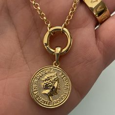 Fine casting made Queen Elizabeth inspired coin pendant in 18k gold filled. A great addition for those looking to have many pendants in a necklace or even bracelet. You may create your own collection, exploring the possibilities of jewelry making or diy (do it yourself) jewelry. Size with bail: 1" length Coin diameter: 0.75 inches Hypoallergenic jewelry Guarantee against tarnish Water resistant Rigorously manufactured under CA Prop 65 and EU standards Made in Brazil Have available the best jewel The Queen Of England, Creative Department, Queen Of England, Jewelry Metal, Bracelet Chain, Hypoallergenic Jewelry, Exclusive Jewelry, Solid Gold Jewelry, Coin Pendant