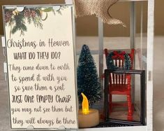 a christmas scene with a candle and a sign that says, christmas in heaven what do they do?