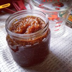 a jar filled with jam sitting on top of a table