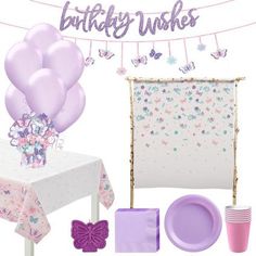 a table topped with lots of purple balloons next to a white table cloth and pink napkins