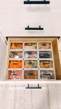 an organized drawer is shown with drawers and trays for food in the bottom compartment