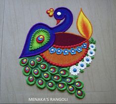 a colorful peacock made out of felt on a wooden surface with a lit candle in its beak