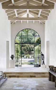 the entrance to an elegant house with large arched windows