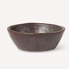 a brown bowl sitting on top of a white table