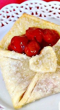 some food is on a white plate with a red and white table cloth in the background