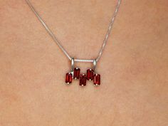 Garnet Pendant set with a Natural Garnet in a baguette cut & deep red color with flawless clarity, at 5x3mm each, 1.5 Carat combined, sourced from Mozambique. Emerald Cut Pendant design made of Solid 925 Sterling Silver ☞ made to last. Free Silver Chain with every Pendant order, 18 inch Silver chain (46 cm) ✓ Matching Ring: www.etsy.com/uk/listing/973361588 Matching Earrings - please ask me January Birthstone - Genuine & Natural Stones ❀ ⌛Last Pendant left ⌛ ❀ Each Natural Gem is unique & will h Ruby Eternity Band, January Birthstone Necklace, Baguette Necklace, Natural Ruby Ring, Red Pendants, Dainty Pendant, Garnet Pendant, Garnet Jewelry, Deep Red Color