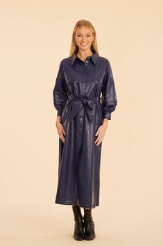 Wrap yourself in comfort and style with our Faux Leather Belted Maxi Dress, a sleek and stylish piece perfect for cooler days. This dress offers a chic buttoned front, ruched balloon sleeves for added volume and drama, and a belted waist to define your silhouette. Its faux leather material adds a layer of sophistication while keeping you cozy, making it an essential wardrobe choice for fall. Faux leather Maxi length Belted waist Long ruched balloon sleeves Available in Navy, Black Dry clean Styl Leather Maxi Dress, Belted Maxi Dress, Fur Top, Linen Gauze, Essential Wardrobe, Iconic Dresses, Faux Leather Belts, Maxi Dress Navy, Wrap Cardigan