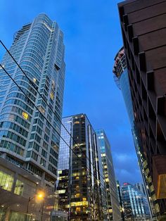 some very tall buildings in the city at night