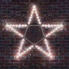 a brick wall with a lighted star on it's side in front of the camera