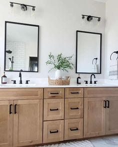 a bathroom with double sinks and mirrors on the wall