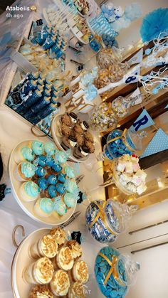 a table filled with blue and white desserts