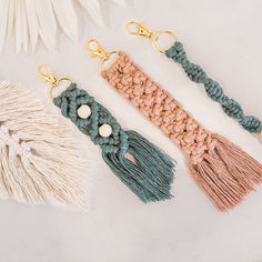 three tasseled key chains with beads on them