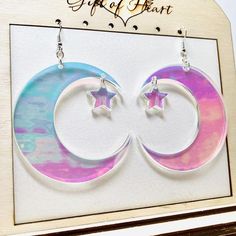 Large crescent moon iridescent earrings with a dangling star. I had a request from a buyer to create this design and I love the way they turned out. These rainbow earrings reflect all the colors around you and appear to be different colors under different lighting. Earrings measured 2.5 inches in diameter, not counting the hooks. These statement earrings can be made into clip on earrings.Earrings will be placed in a gift box, carefully packed and shipped, perfect as a gift for yourself or a love Celestial Iridescent Earrings For Gift, Clay Games, Lighting Earrings, Emo Earrings, Bird Eyes, Iridescent Earrings, Pastel Punk, Iridescent Acrylic, Making Resin Jewellery