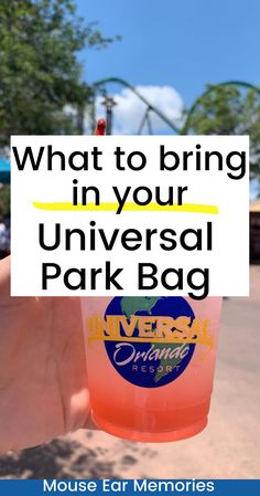 a person holding up a plastic cup with the words what to bring in your universal park bag