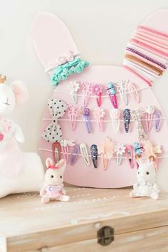 a pink shelf with some bunny figurines on it